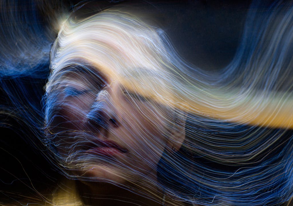 Surreal portrait of a woman with light trails, creative motion blur effects.